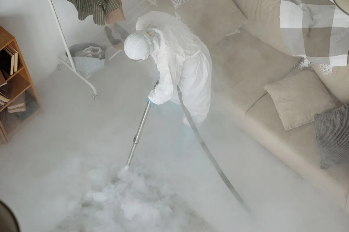 Biohazard cleanup technician in protective equipment, Darby, PA